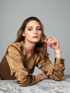 Retrato de estudio de una mujer con blusa de satén dorado y mirada sofisticada. Dirección de arte por nuestra agencia de contenido